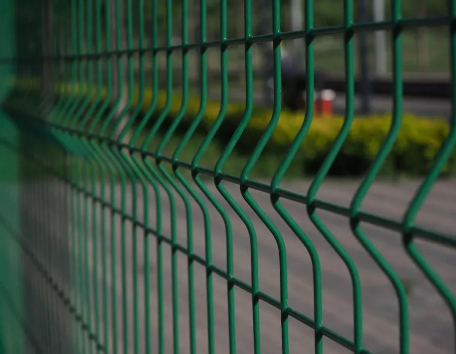 Close view of green three-dimensional welded fence bends