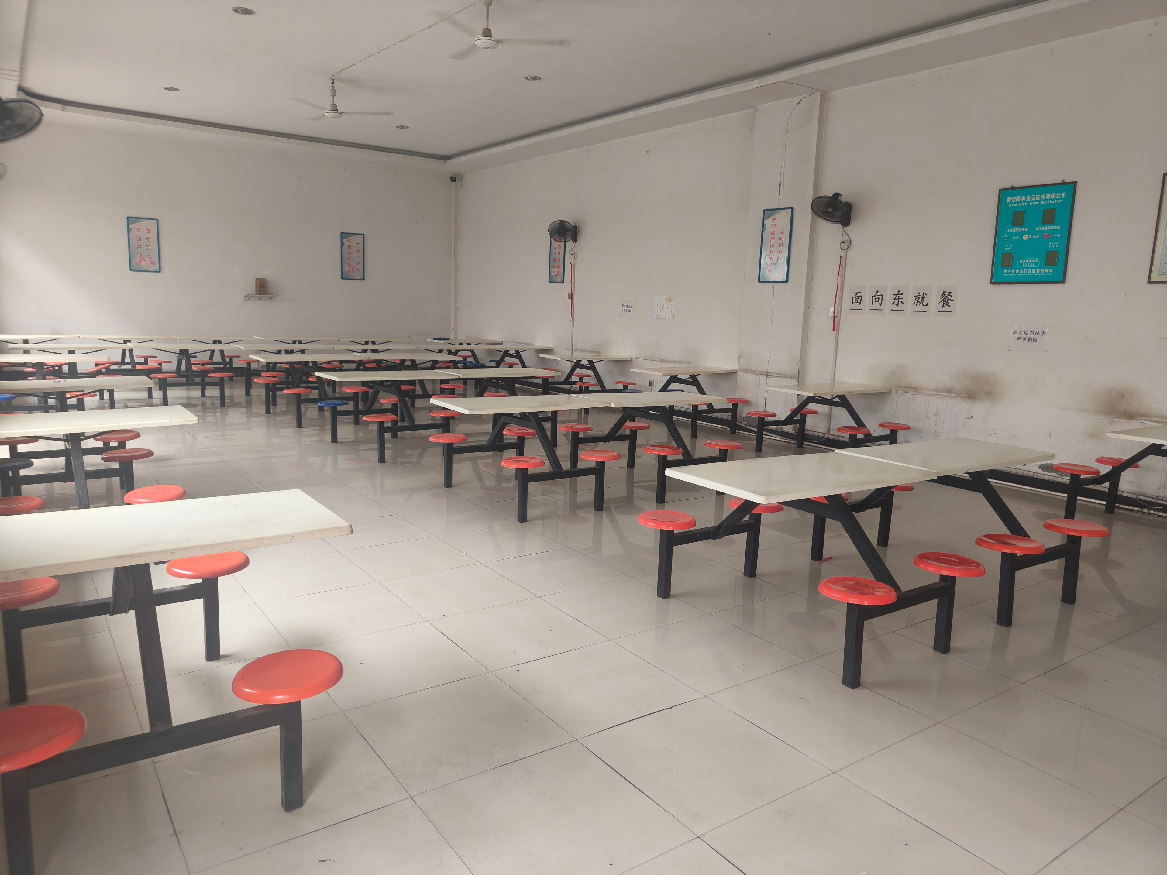 Person standing in a factory with machinery in the background