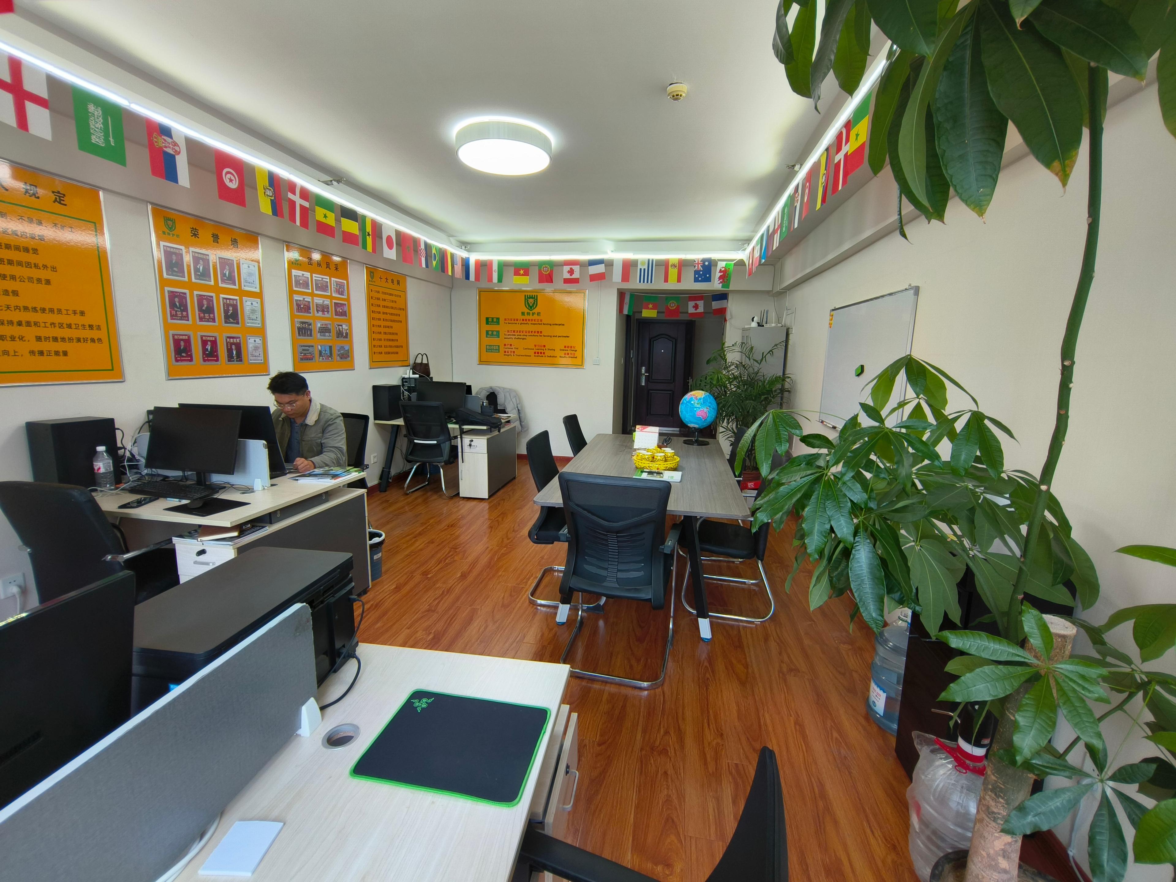 Person standing in a factory with machinery in the background