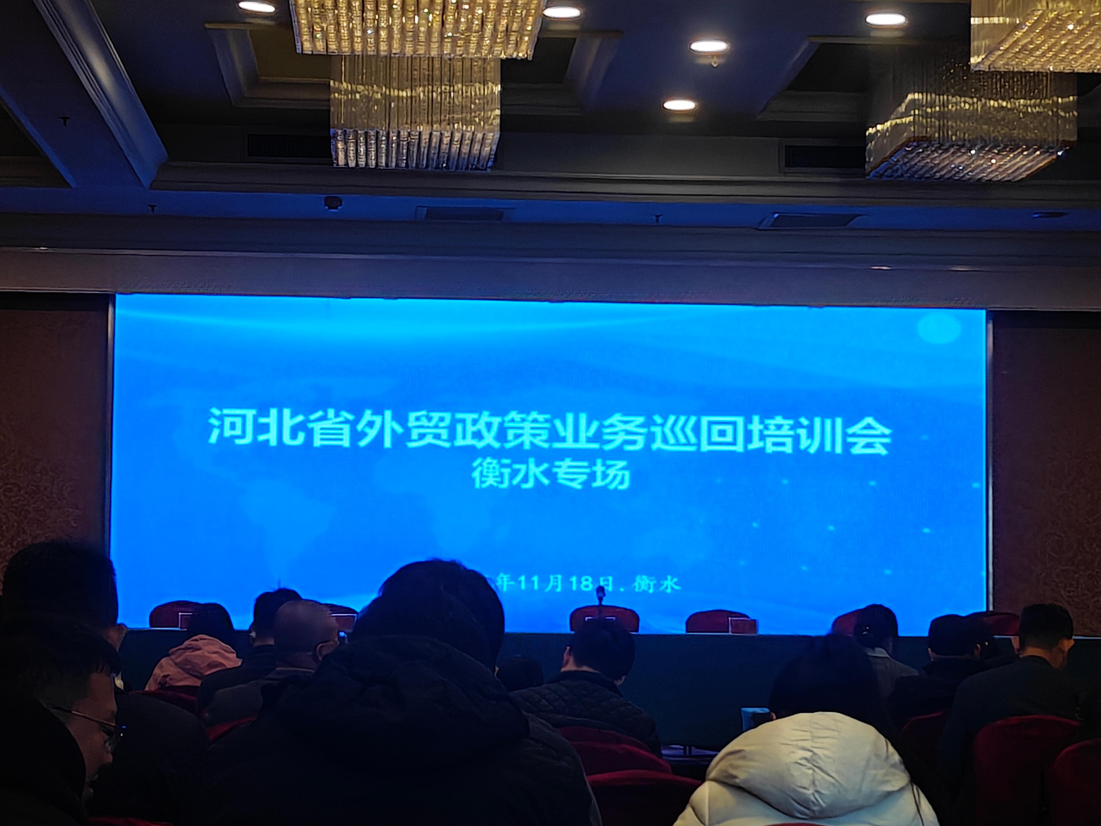 Person standing in a factory with machinery in the background