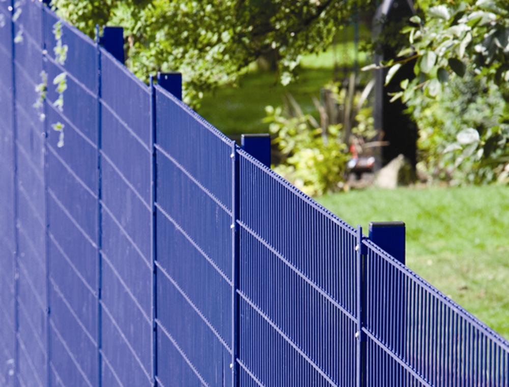 Person standing in a factory with machinery in the background