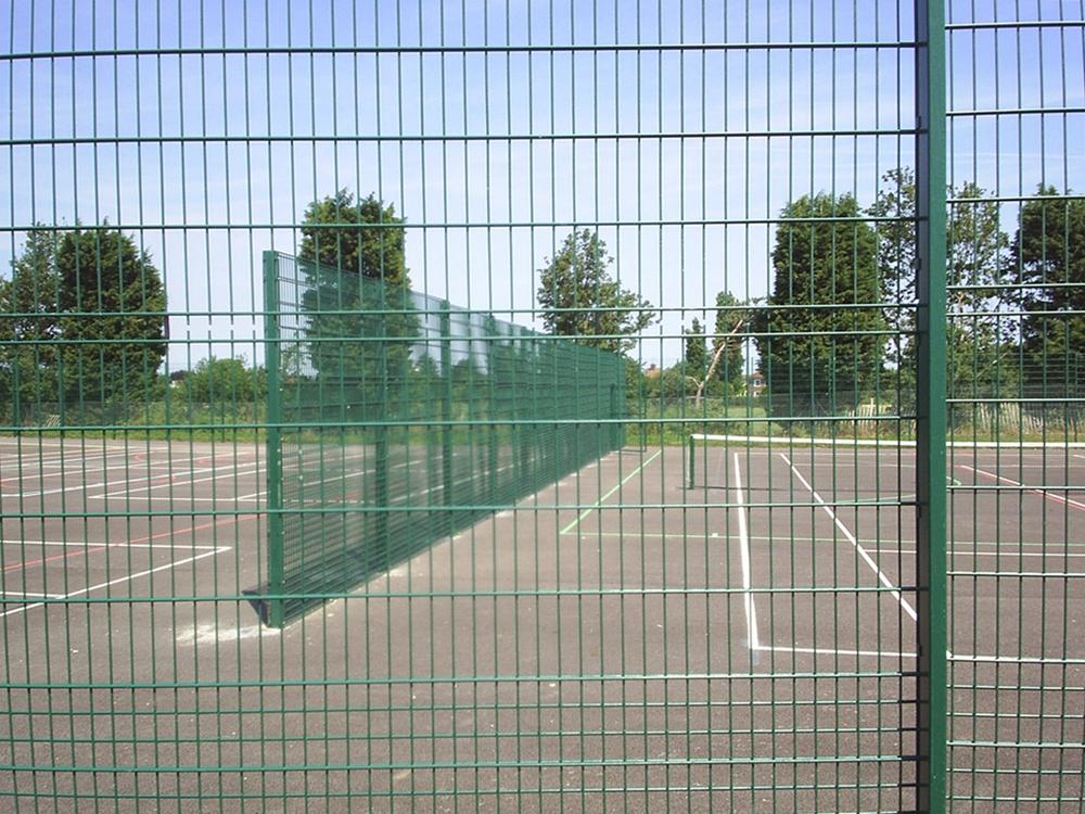 Person standing in a factory with machinery in the background