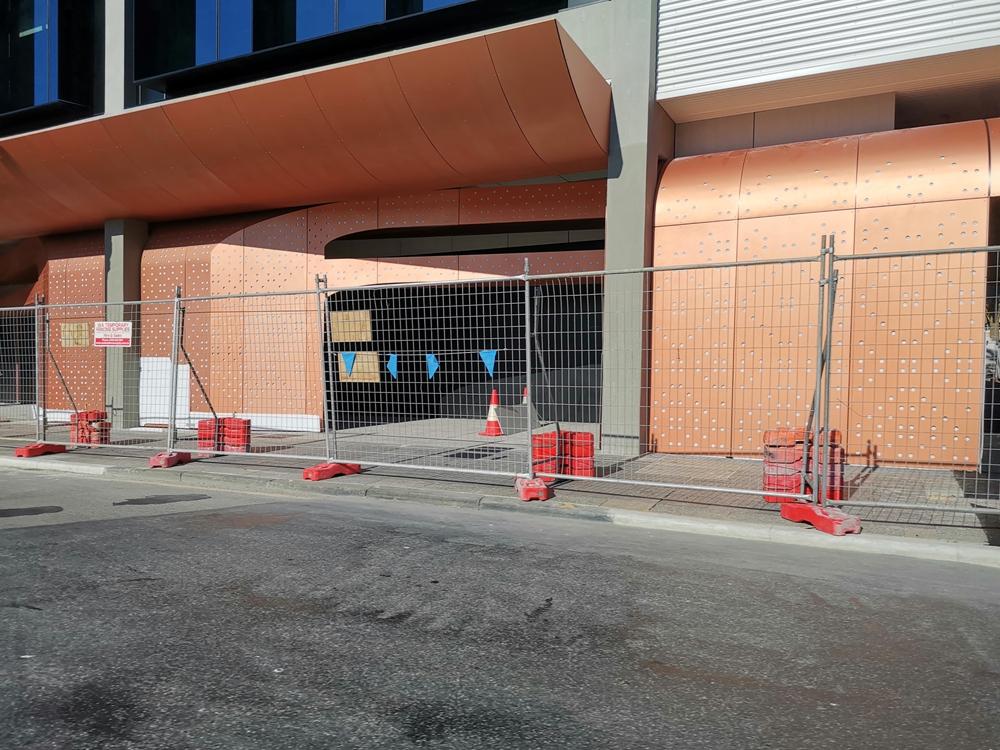 Person standing in a factory with machinery in the background