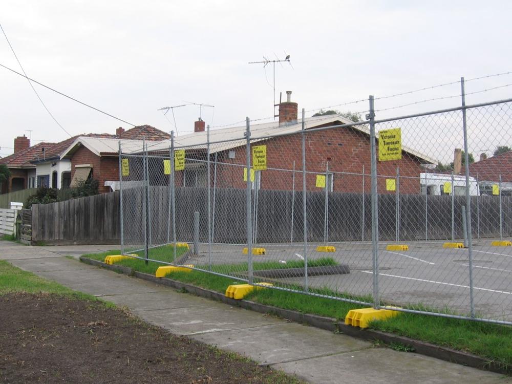 Person standing in a factory with machinery in the background