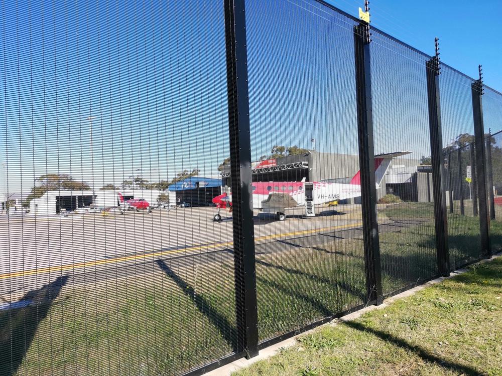 Person standing in a factory with machinery in the background