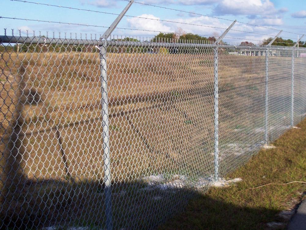 Person standing in a factory with machinery in the background