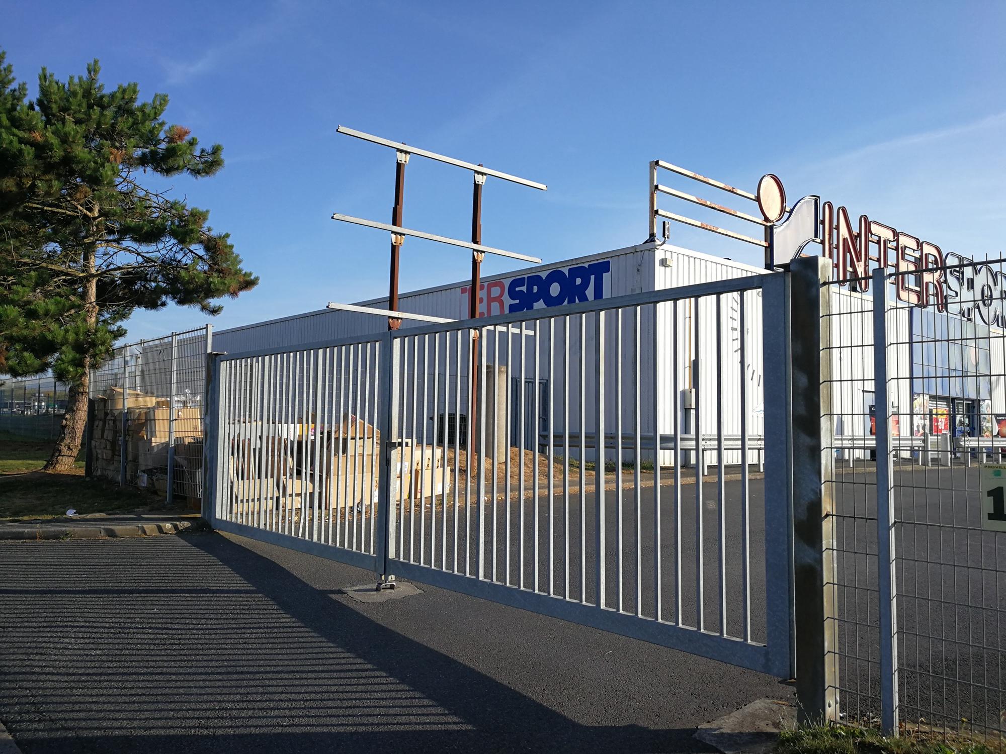 Person standing in a factory with machinery in the background