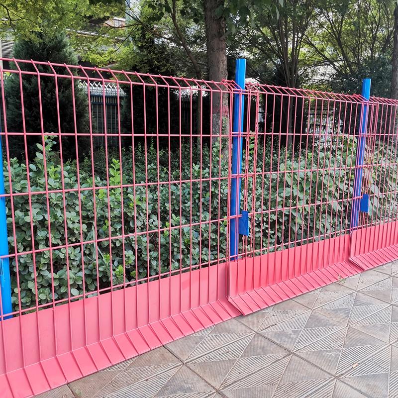 Person standing in a factory with machinery in the background