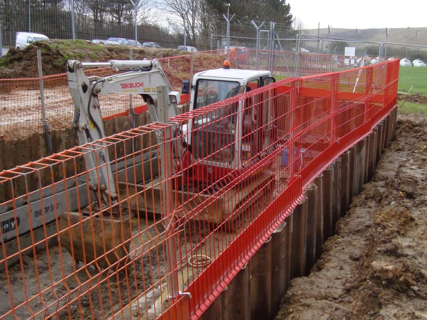 Person standing in a factory with machinery in the background