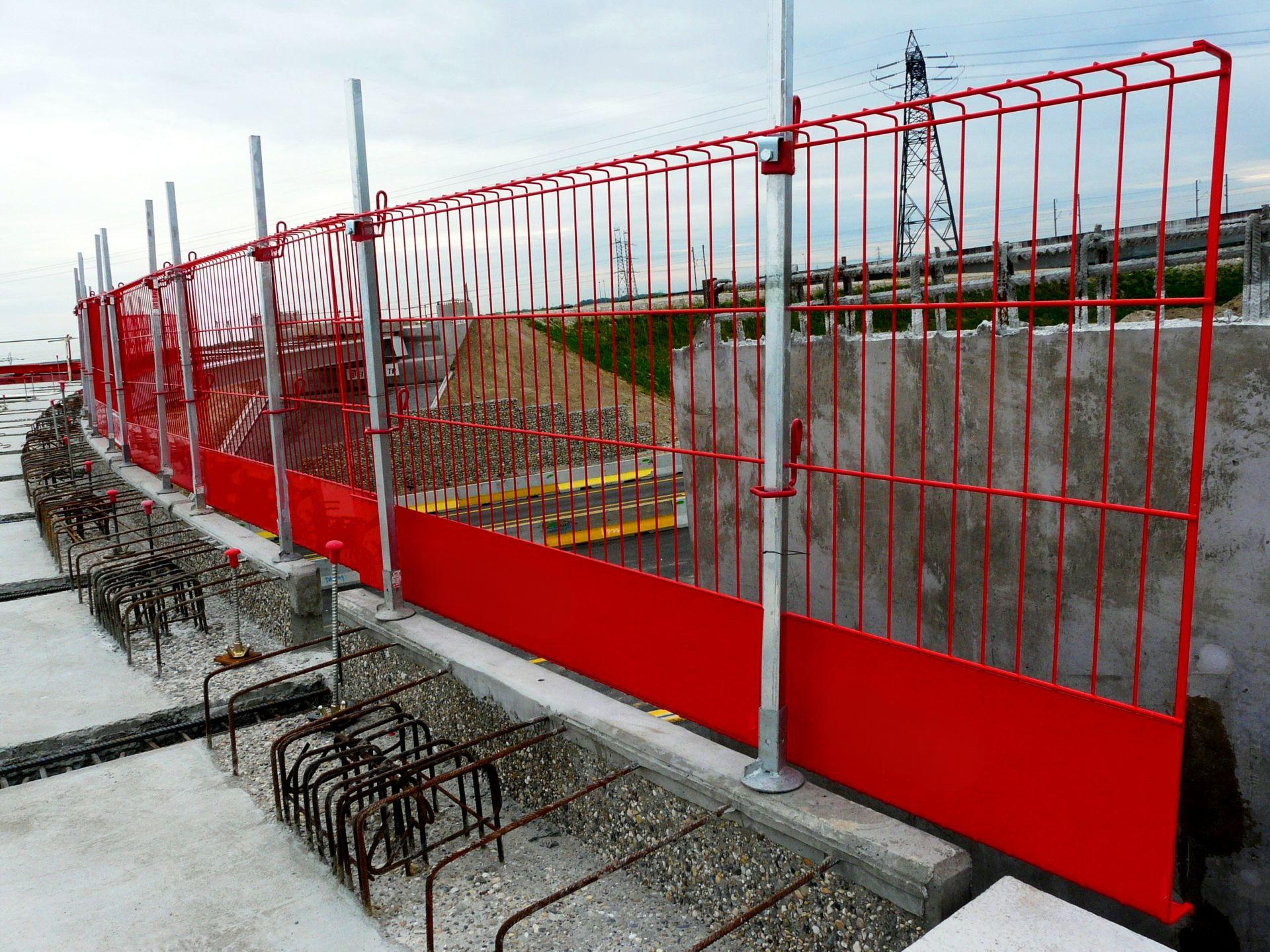 Person standing in a factory with machinery in the background