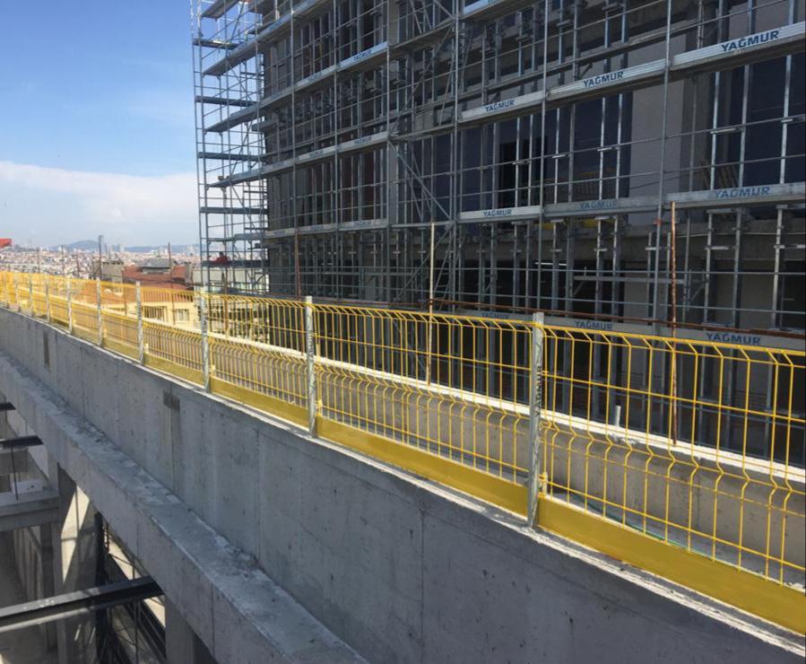 Person standing in a factory with machinery in the background