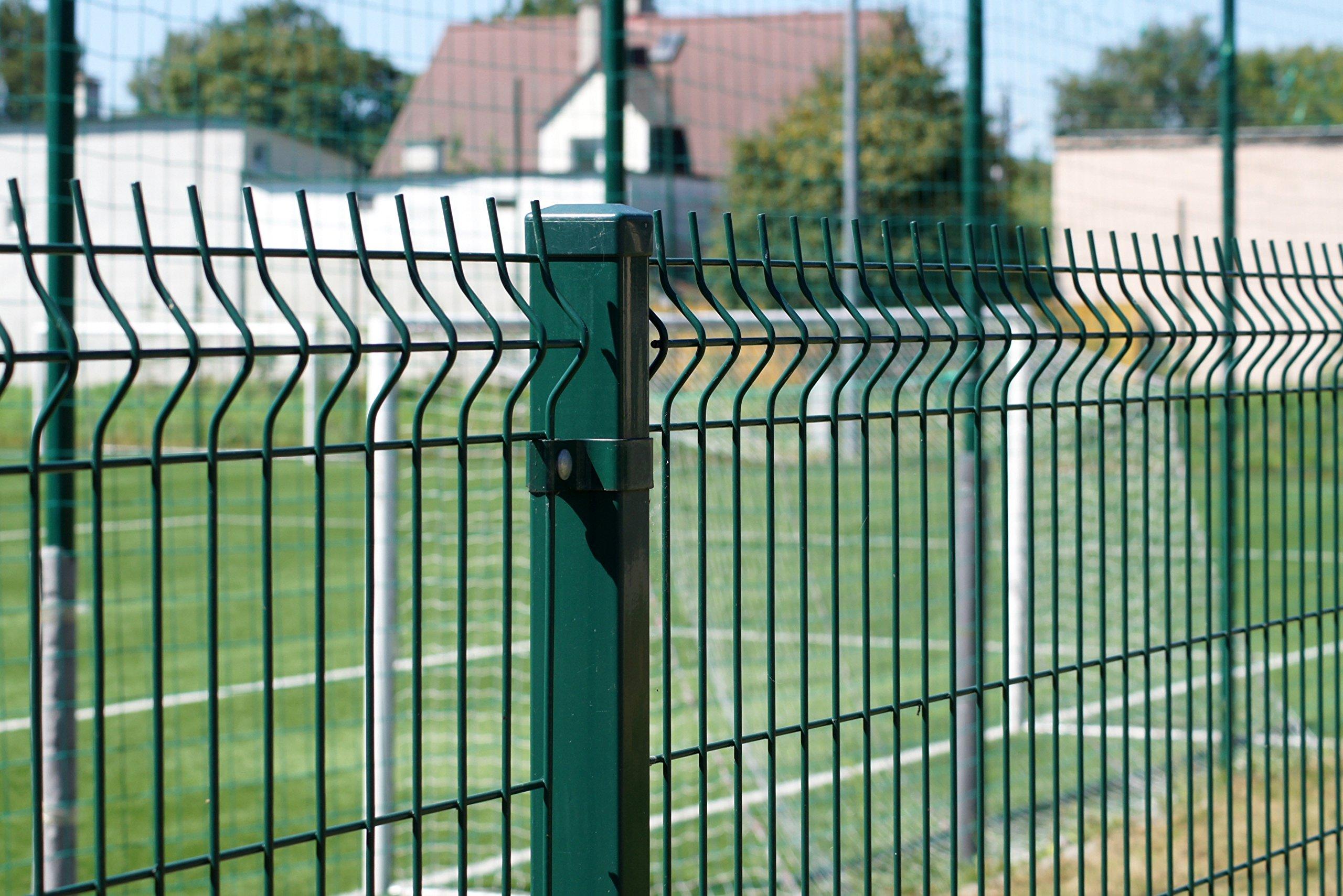 Person standing in a factory with machinery in the background