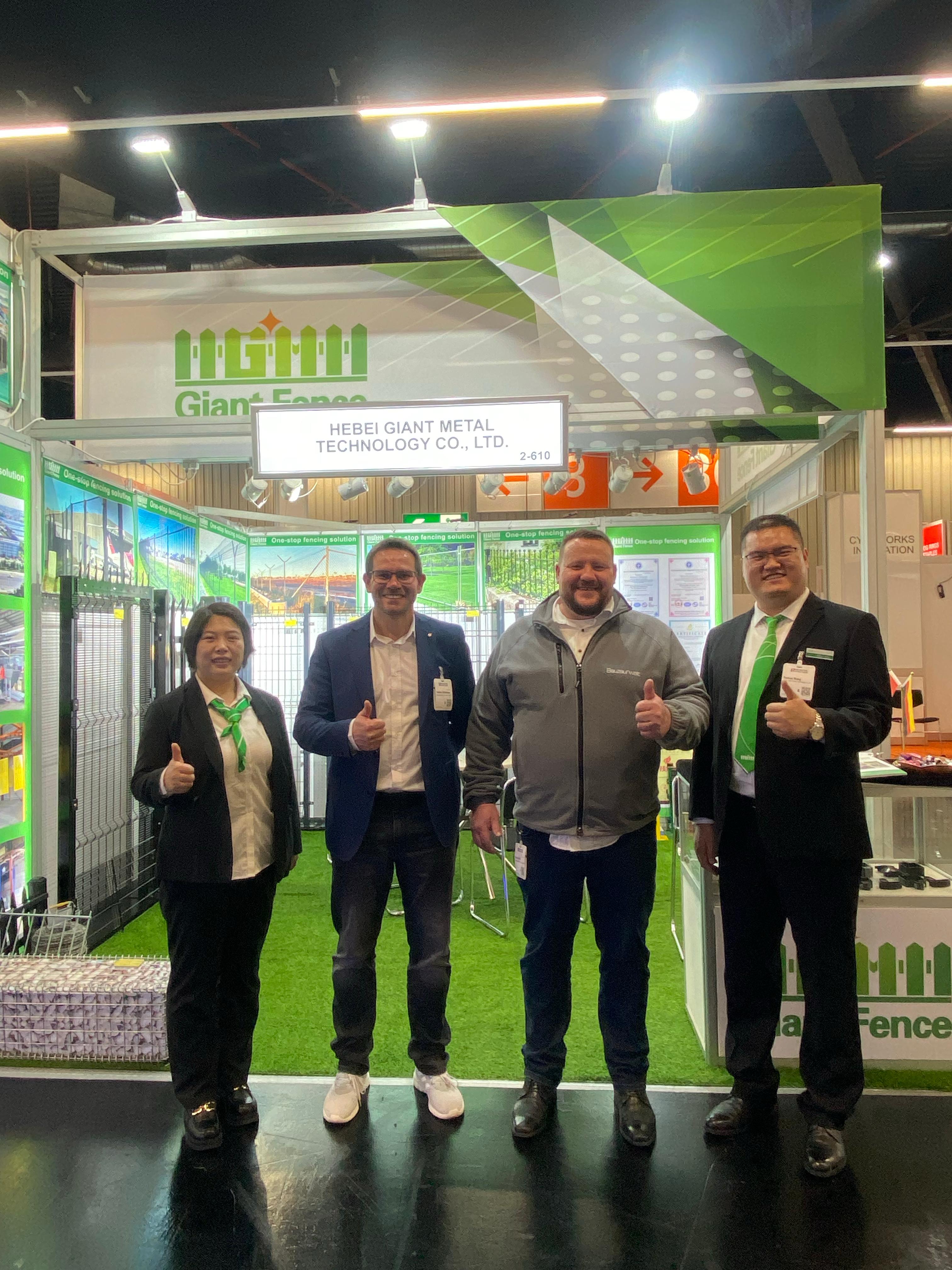 Person standing in a factory with machinery in the background