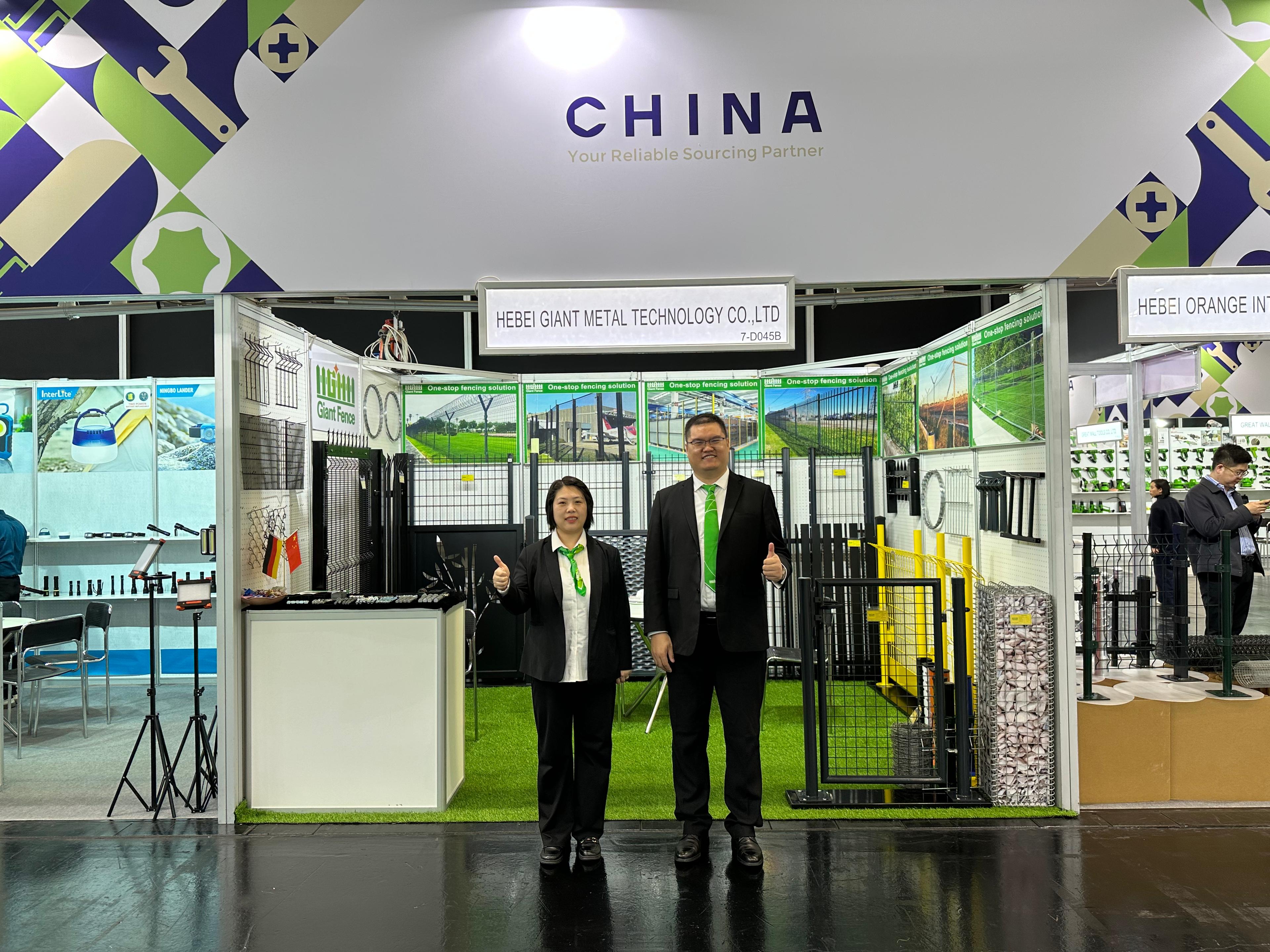 Person standing in a factory with machinery in the background