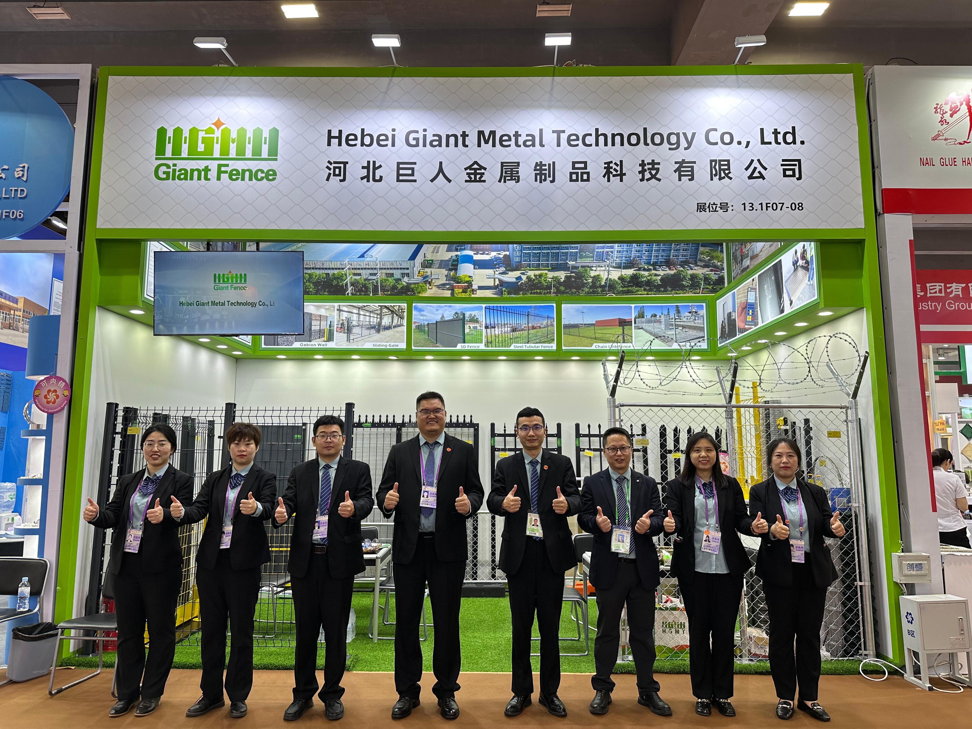 Person standing in a factory with machinery in the background