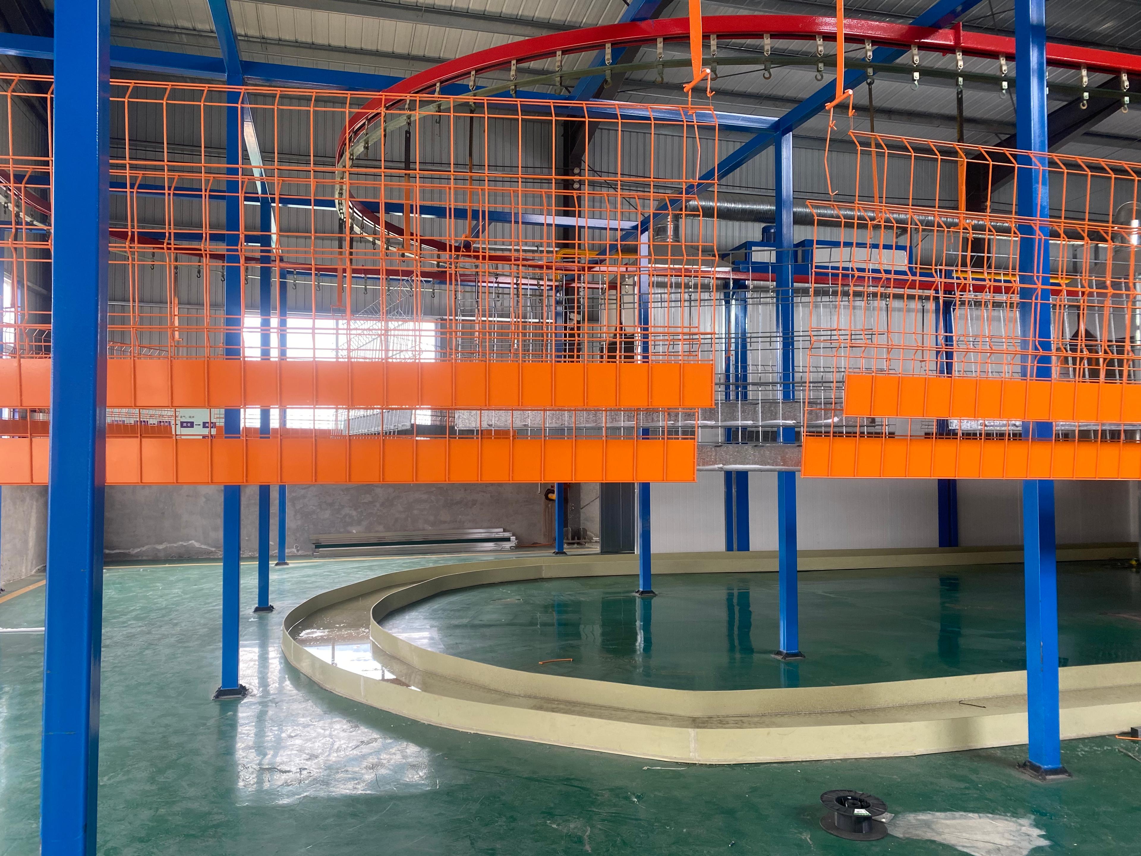 Person standing in a factory with machinery in the background