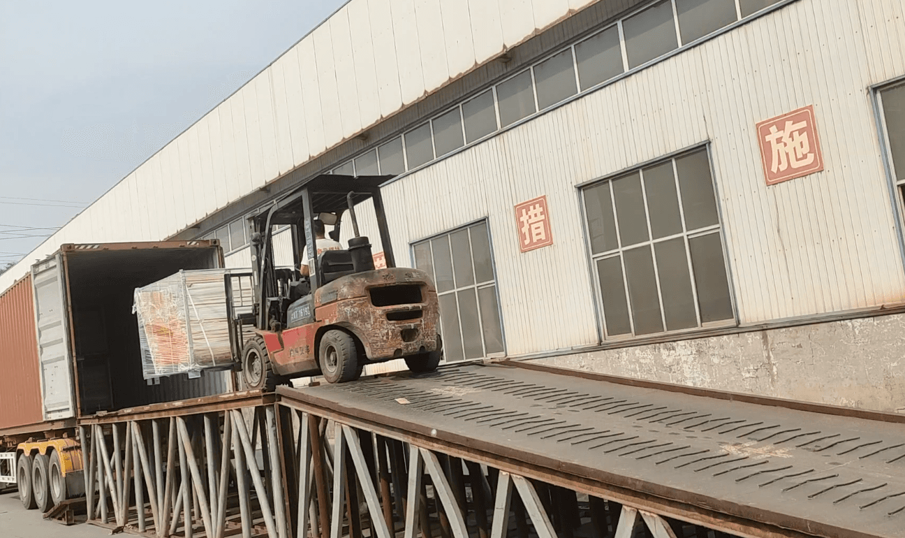Person standing in a factory with machinery in the background