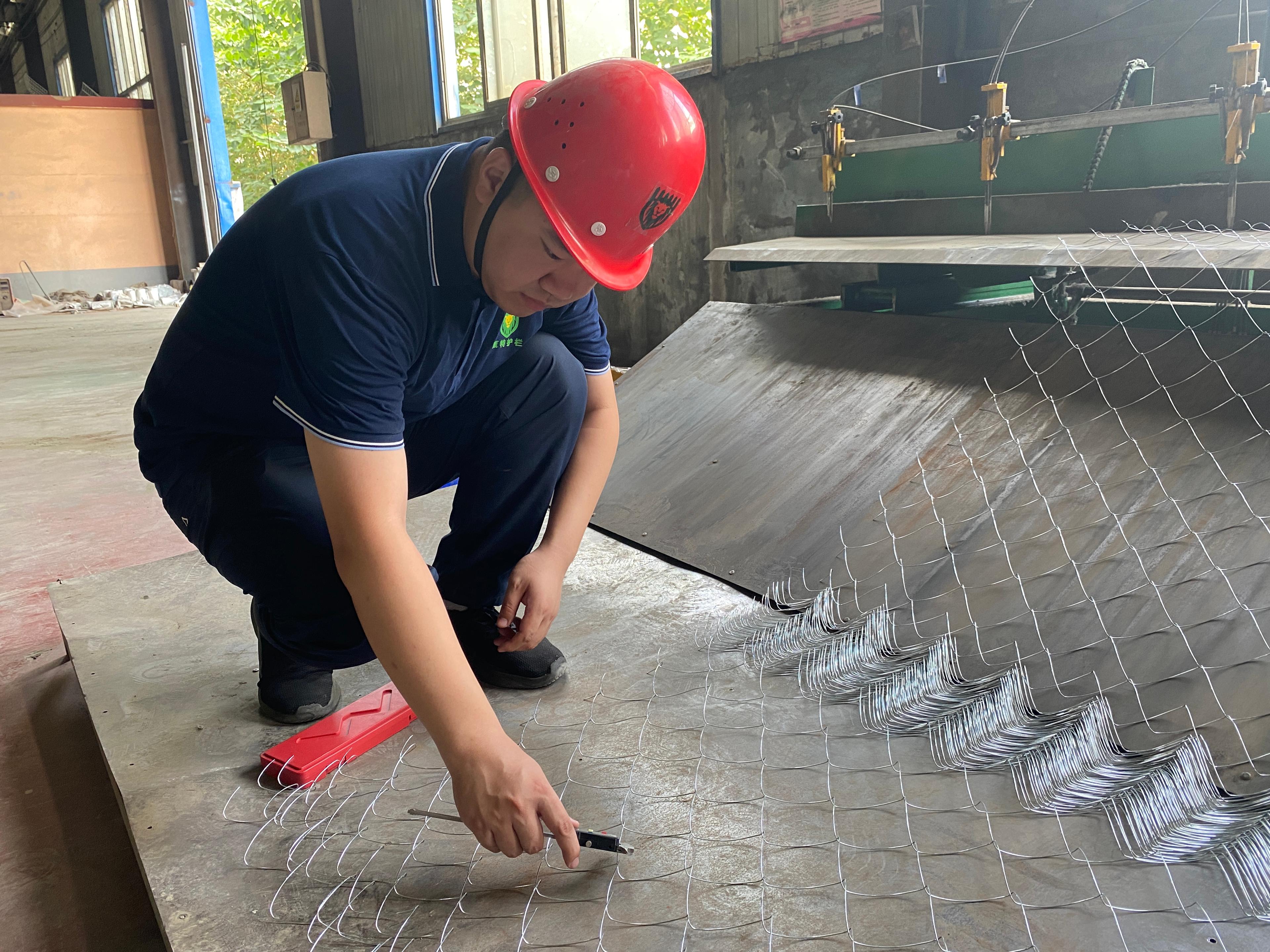 Person standing in a factory with machinery in the background