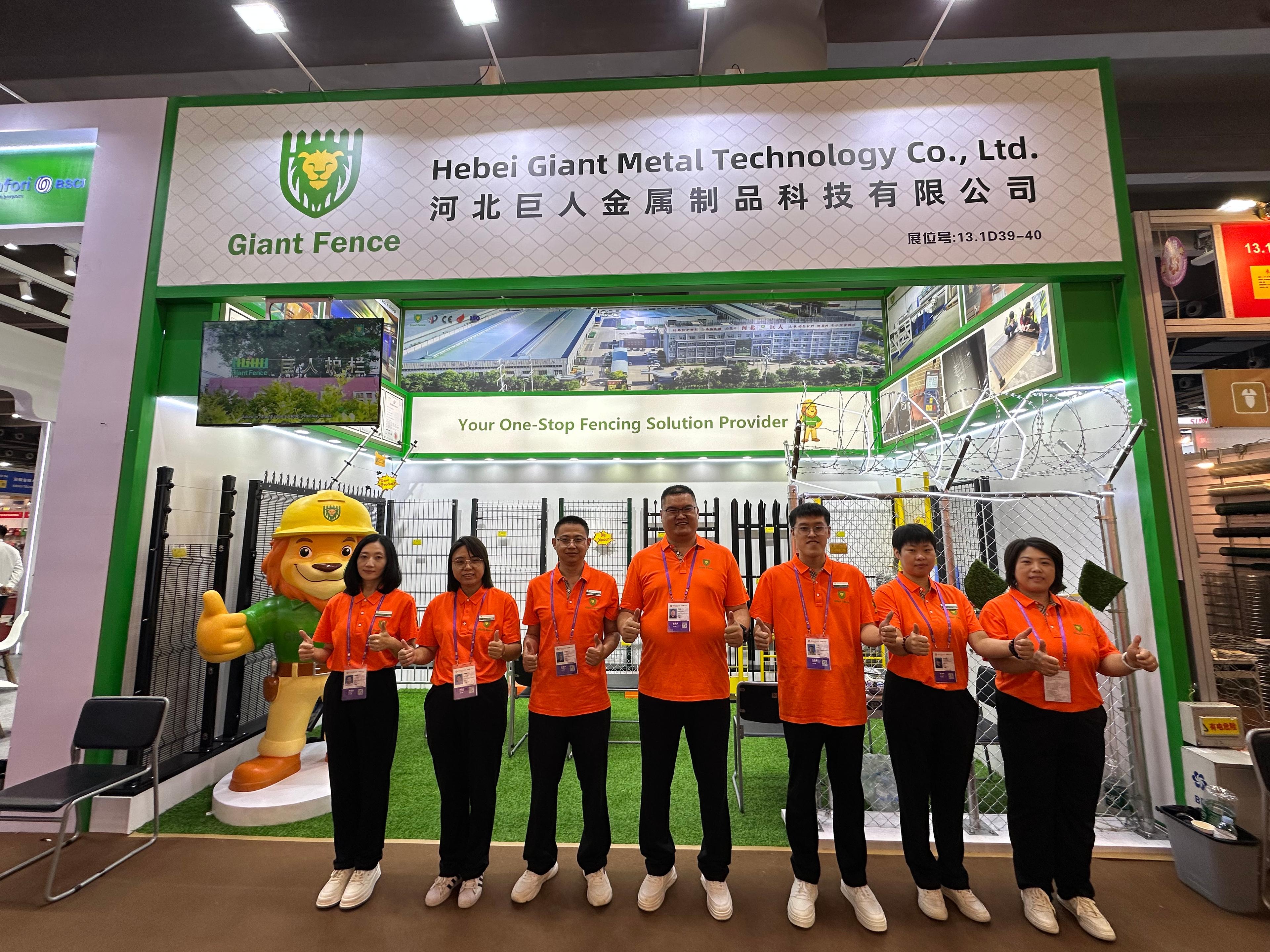 Person standing in a factory with machinery in the background