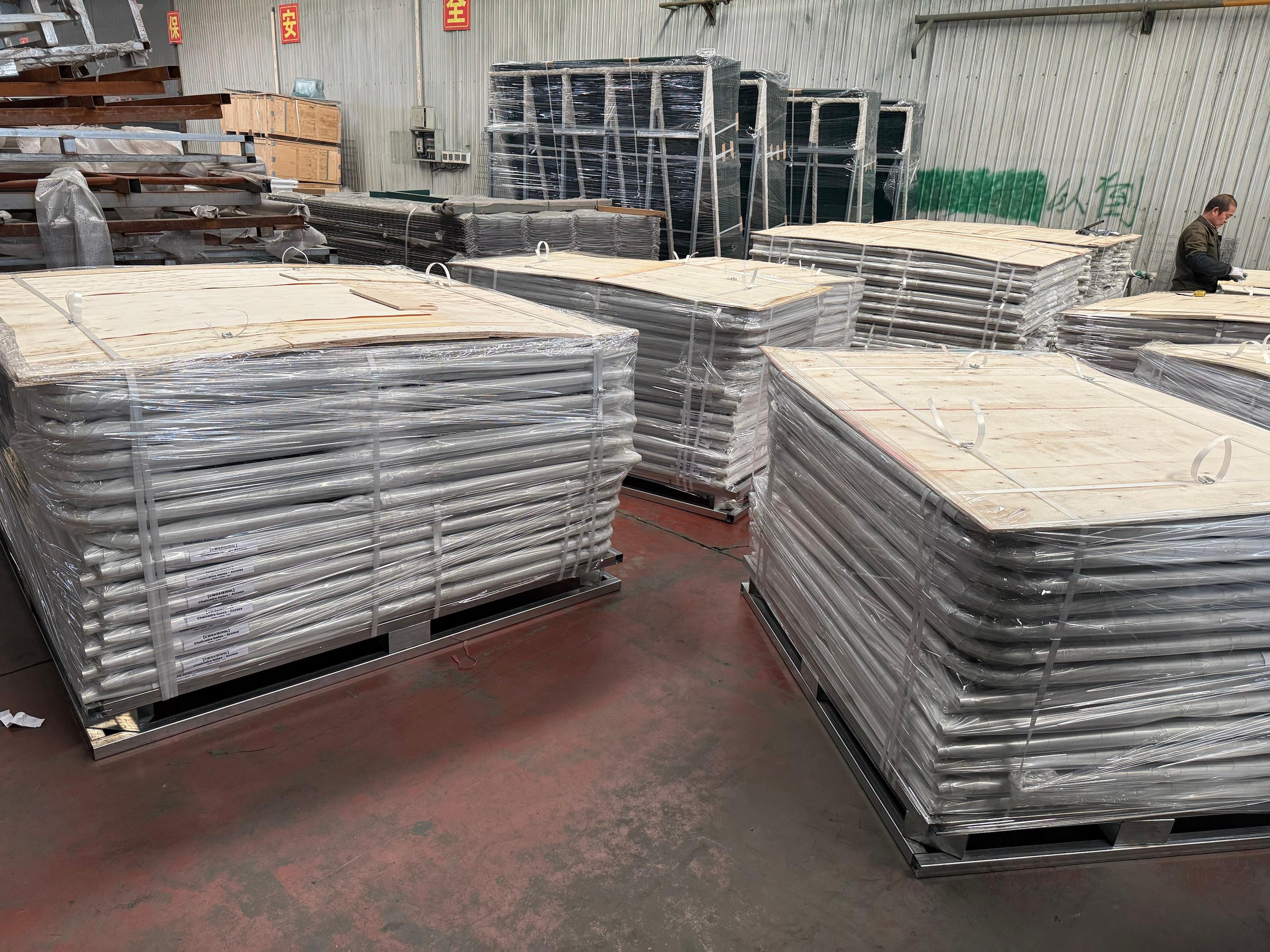 Person standing in a factory with machinery in the background