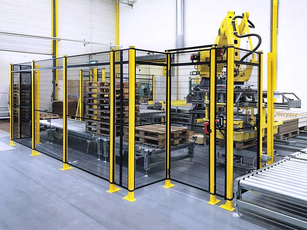 Person standing in a factory with machinery in the background