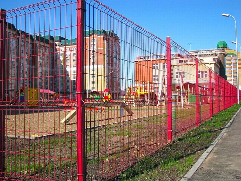 Person standing in a factory with machinery in the background