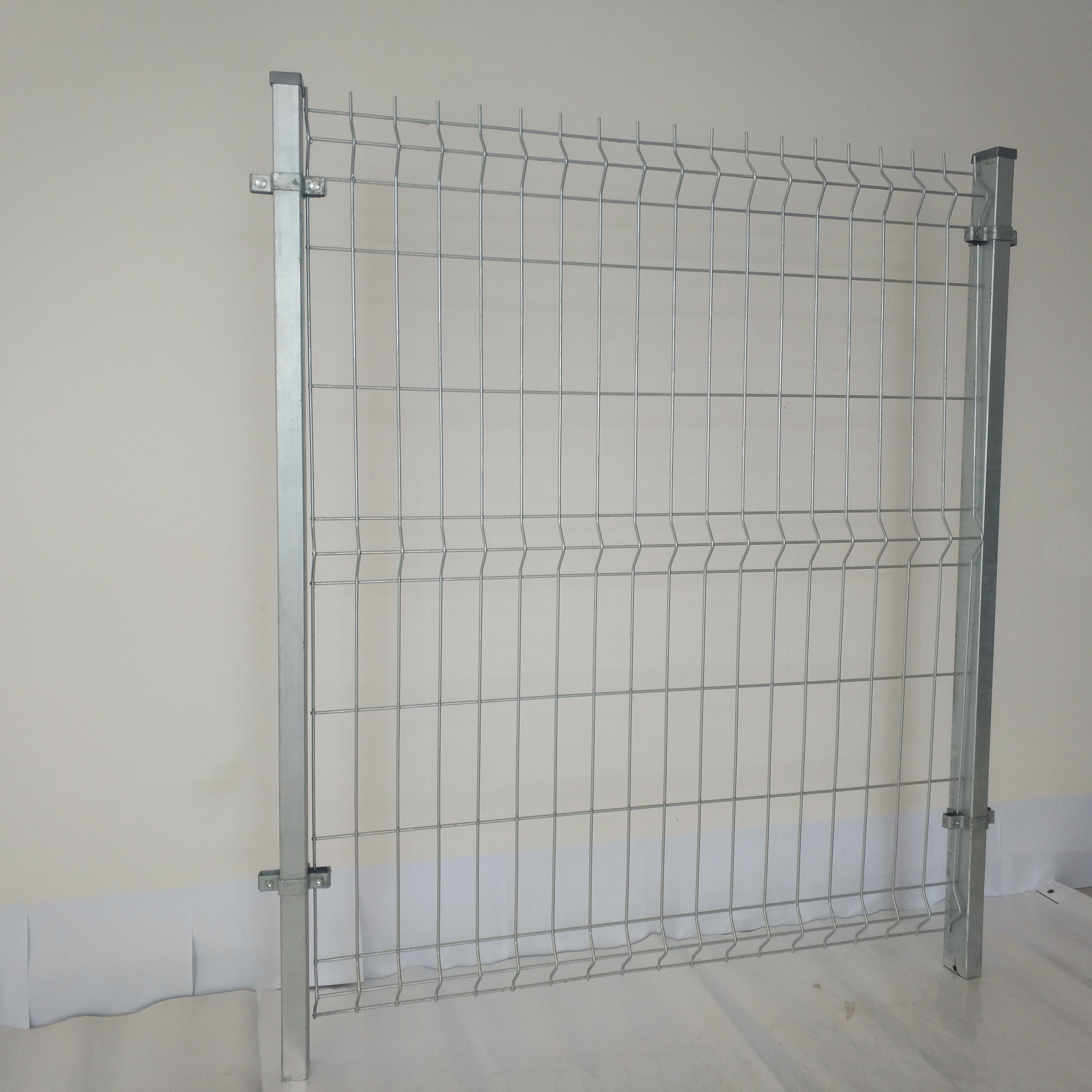 Person standing in a factory with machinery in the background