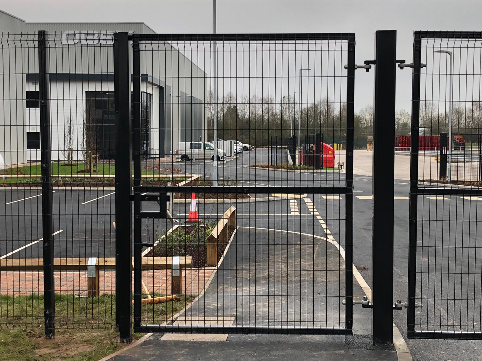 Person standing in a factory with machinery in the background